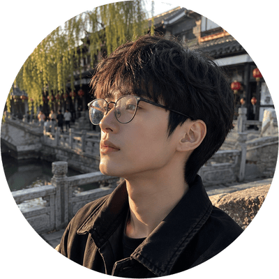 A circular profile picture featuring a young man with round glasses looking aside against a scenic traditional river bridge backdrop