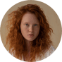 Caucasian female user with red hair. 